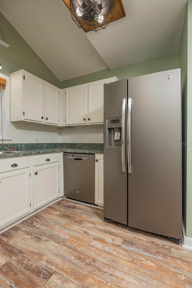 kitchen featuring white cabinets, stainless steel appliances, lofted ceiling, and light hardwood / wood-style floors