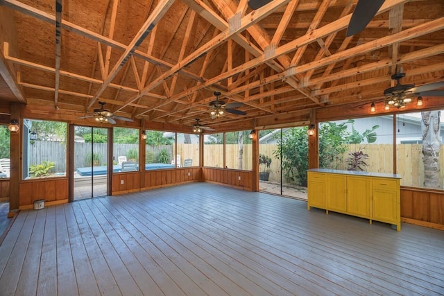 unfurnished sunroom with vaulted ceiling and a healthy amount of sunlight