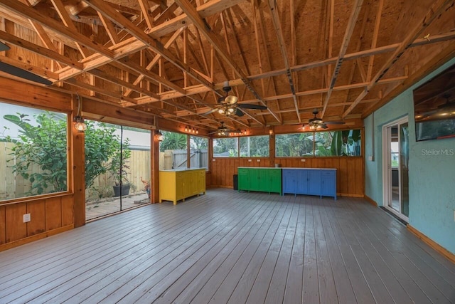 unfurnished sunroom with ceiling fan