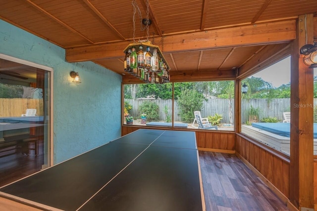 unfurnished sunroom with wood ceiling