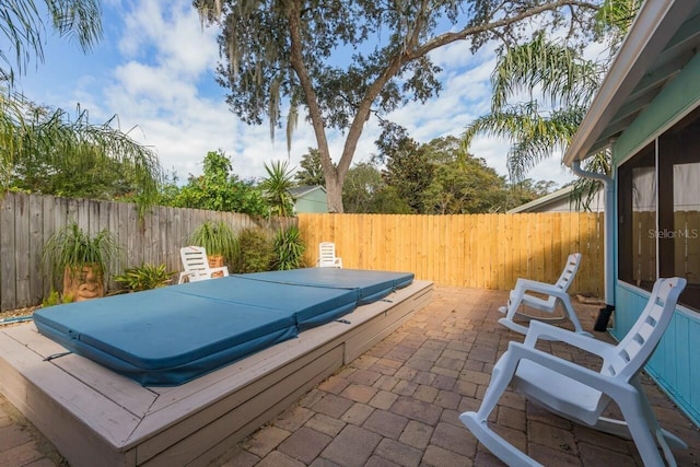 view of patio / terrace featuring a covered hot tub