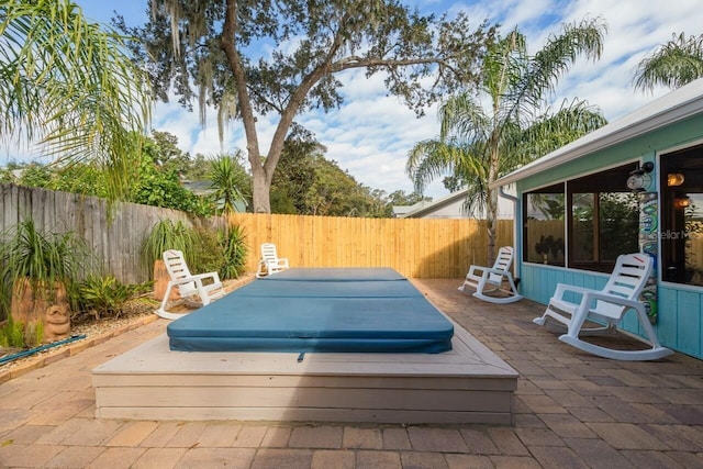 view of patio / terrace with a covered hot tub