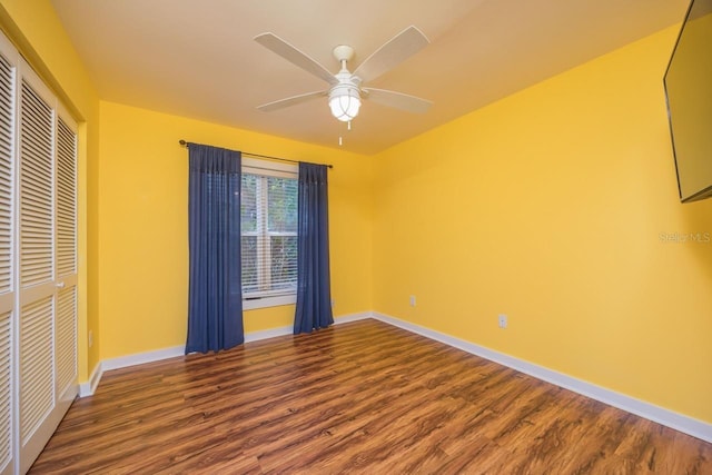 unfurnished bedroom featuring hardwood / wood-style floors, a closet, and ceiling fan