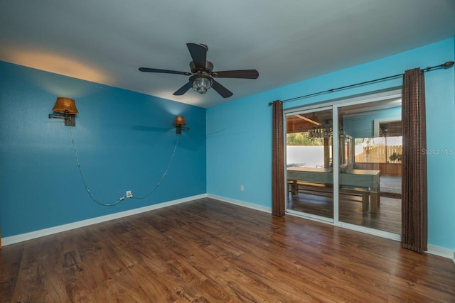 spare room with ceiling fan and dark hardwood / wood-style flooring