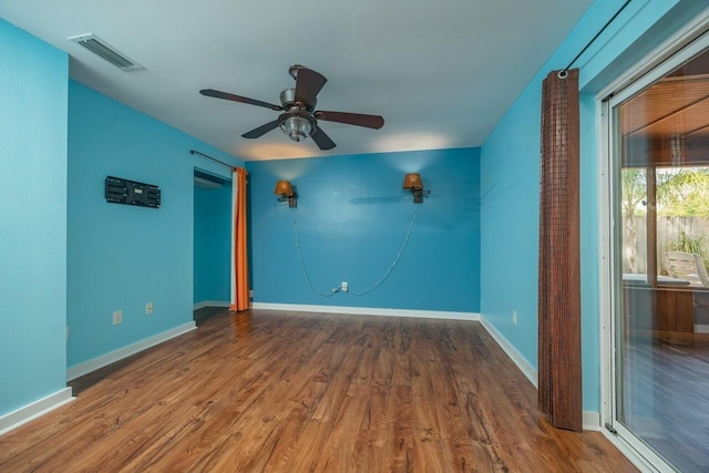 empty room with ceiling fan and hardwood / wood-style floors