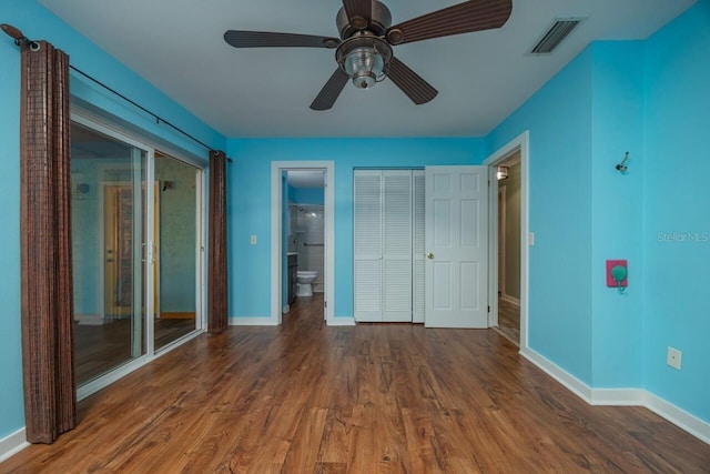 unfurnished bedroom with connected bathroom, ceiling fan, and dark hardwood / wood-style floors