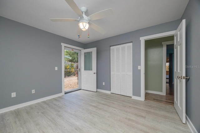 unfurnished bedroom with access to exterior, a closet, light hardwood / wood-style floors, and ceiling fan