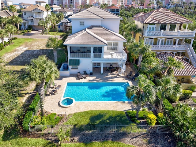 back of house with a patio, a balcony, and a fenced in pool