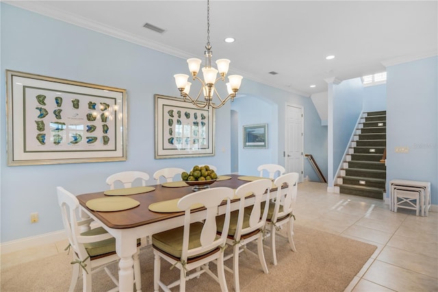 dining area with light tile patterned floors, an inviting chandelier, and ornamental molding