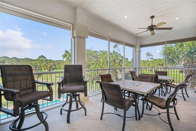 sunroom featuring ceiling fan