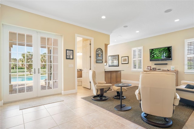 sitting room featuring french doors, light tile patterned flooring, and ornamental molding