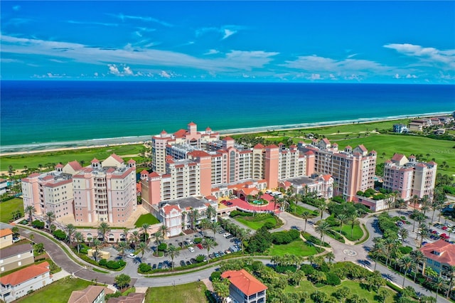 aerial view with a water view and a beach view