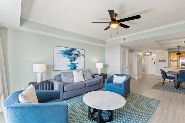 200 Ocean Crest Dr Unit 515, Palm Coast, FL 32137 - living room featuring wood finished floors, a ceiling fan, a tray ceiling, and crown molding
