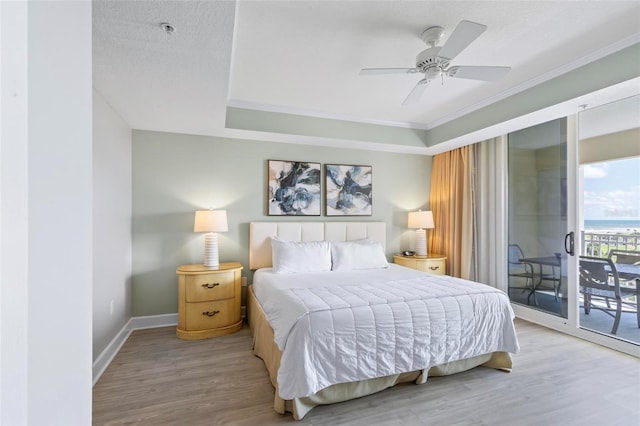 bedroom with hardwood / wood-style floors, ceiling fan, access to exterior, ornamental molding, and a textured ceiling