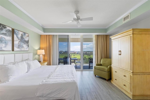 bedroom with crown molding, ceiling fan, access to exterior, light wood-type flooring, and a wall of windows