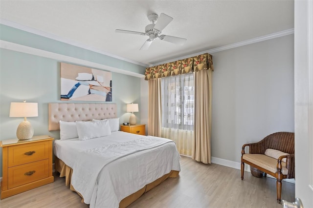 bedroom with ceiling fan, crown molding, and light hardwood / wood-style flooring