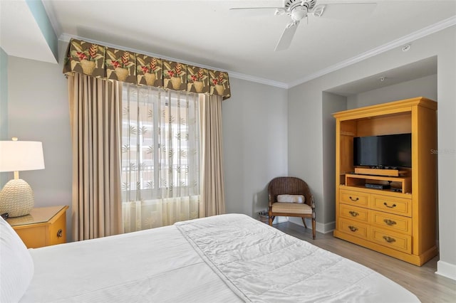 bedroom with ceiling fan, ornamental molding, and light wood-type flooring