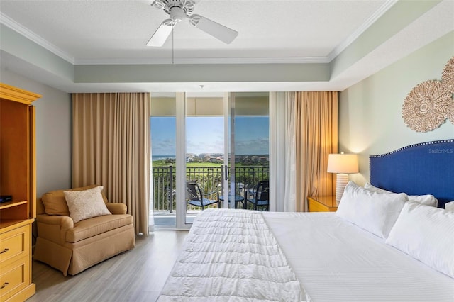 bedroom featuring ceiling fan, access to exterior, light wood-type flooring, and ornamental molding