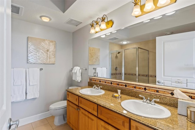 bathroom featuring a textured ceiling, vanity, a shower with door, tile patterned flooring, and toilet