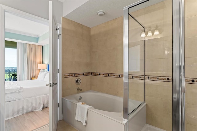 bathroom with separate shower and tub, tile patterned flooring, and a textured ceiling