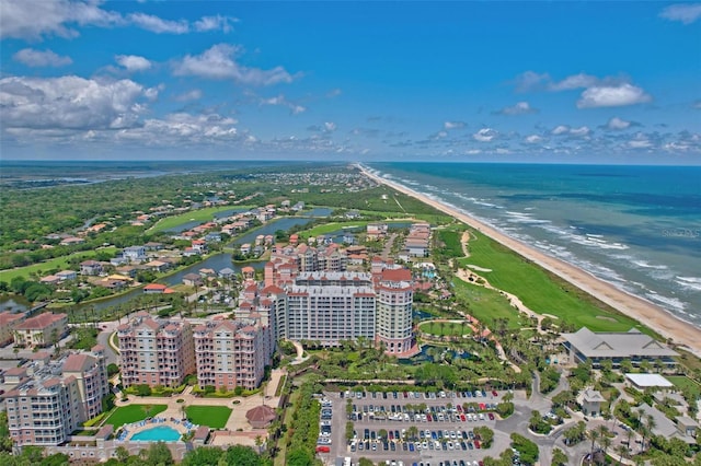 bird's eye view with a water view and a beach view