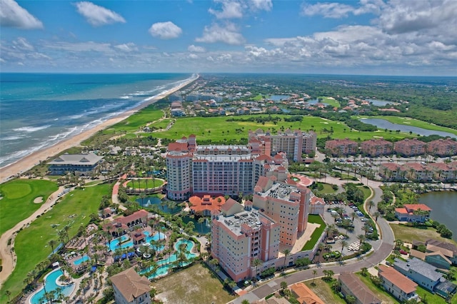 birds eye view of property with a water view and a view of the beach