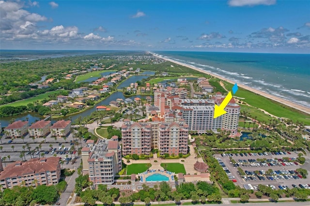 drone / aerial view with a water view and a beach view