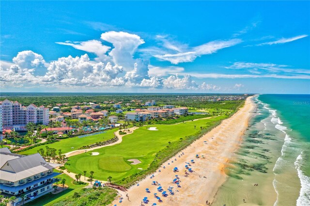 drone / aerial view featuring a beach view and a water view