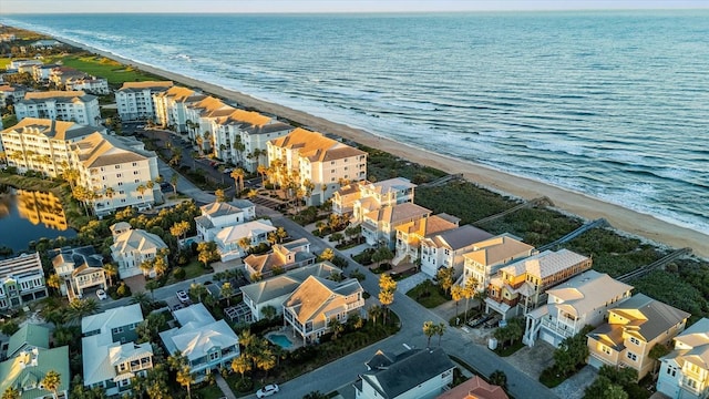 birds eye view of property with a water view and a view of the beach