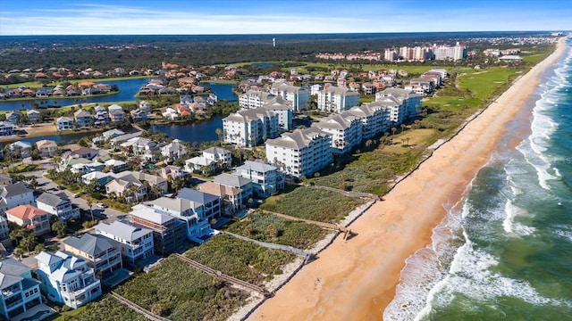 aerial view featuring a view of the beach and a water view