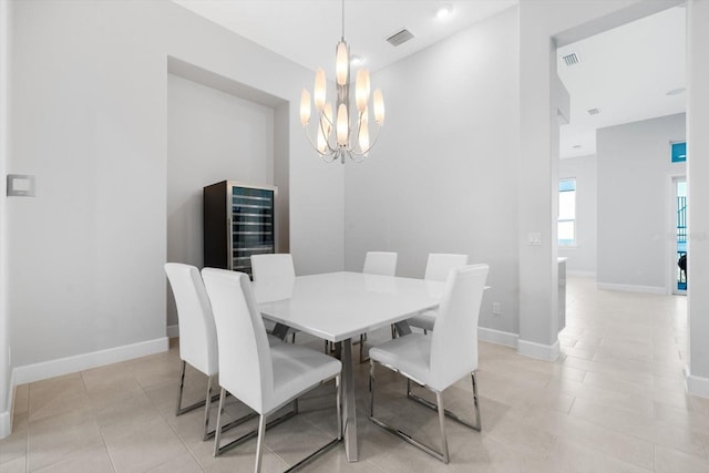 tiled dining area with wine cooler and an inviting chandelier