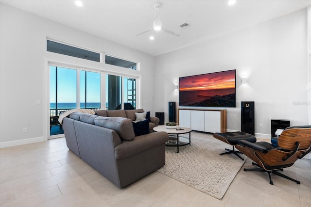 tiled living room with ceiling fan