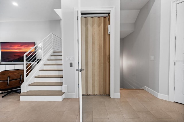 stairway featuring tile patterned flooring