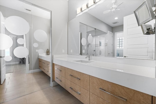 bathroom featuring tile patterned floors, ceiling fan, and vanity