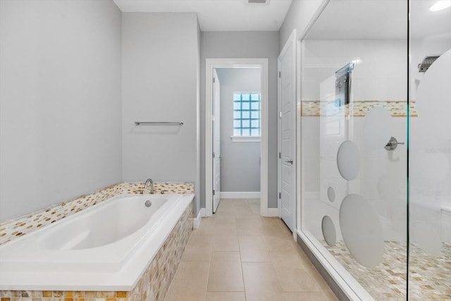 bathroom featuring tile patterned flooring and shower with separate bathtub