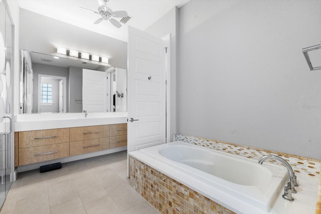 bathroom featuring tile patterned flooring, vanity, ceiling fan, and tiled bath