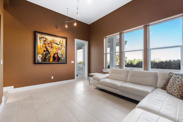 living room featuring lofted ceiling and light tile patterned floors