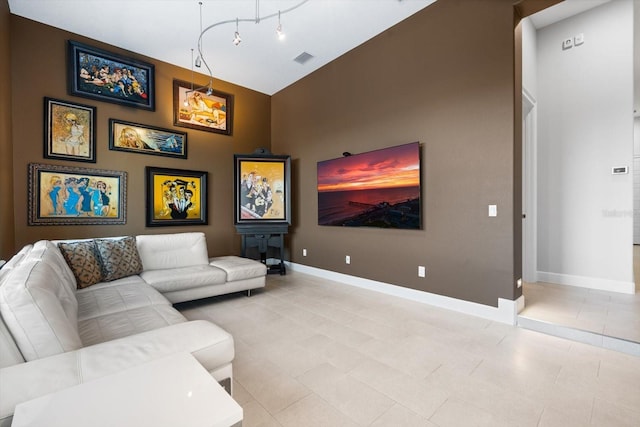 living room with light tile patterned flooring and high vaulted ceiling