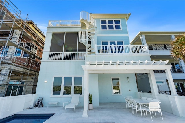 rear view of house with a pergola and a patio area