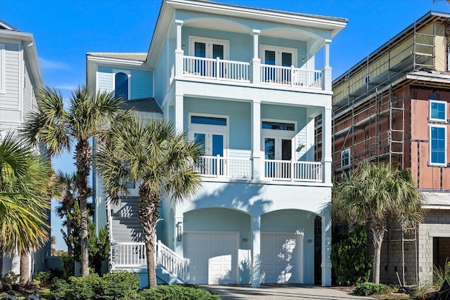 beach home featuring a balcony and a garage