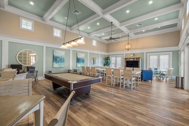 recreation room featuring ceiling fan, a high ceiling, beamed ceiling, billiards, and wood-type flooring