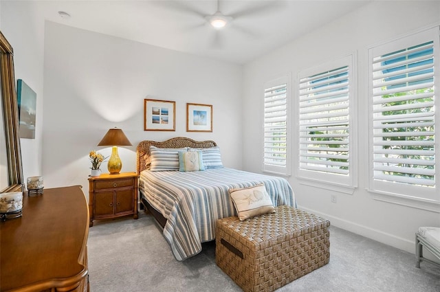 bedroom featuring light carpet and ceiling fan