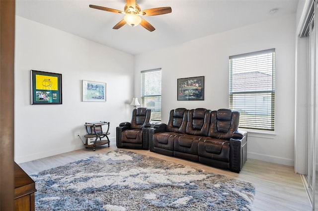 living room featuring light hardwood / wood-style flooring and ceiling fan