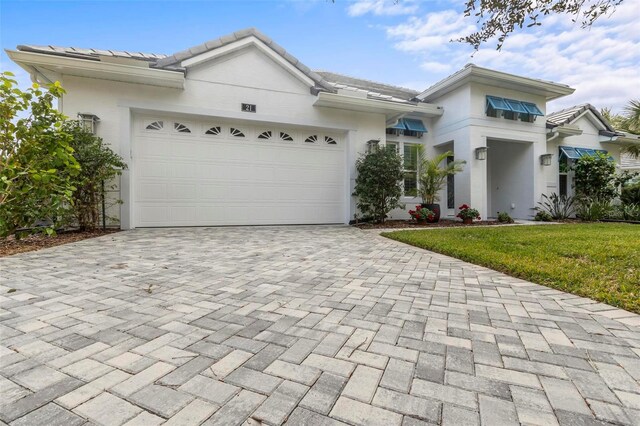 view of front of property featuring a garage and a front lawn