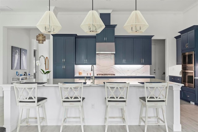 kitchen with blue cabinets, a breakfast bar, a spacious island, and appliances with stainless steel finishes