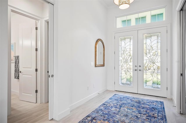 foyer entrance featuring french doors and light wood-type flooring