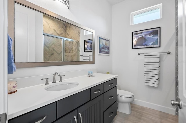 bathroom with walk in shower, vanity, toilet, and wood-type flooring