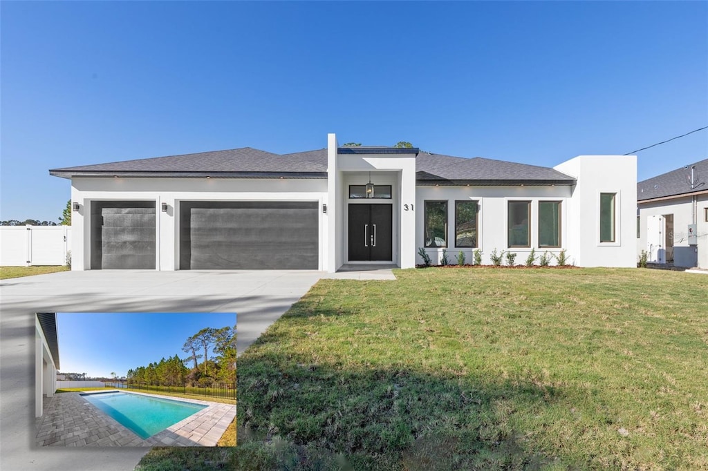 view of front of property with a garage and a front lawn