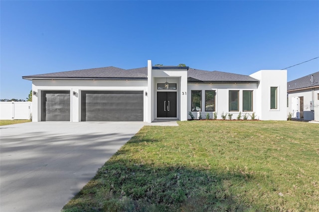 view of front facade featuring a garage and a front lawn