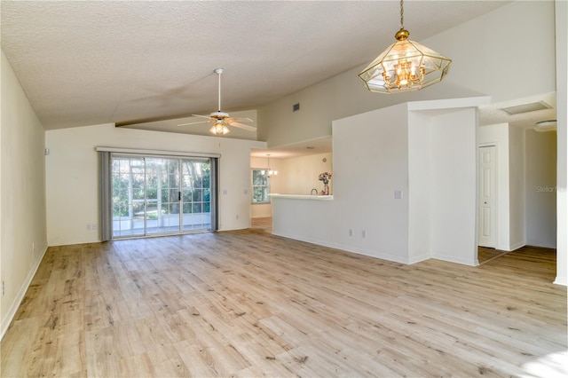 unfurnished living room featuring ceiling fan with notable chandelier, light hardwood / wood-style floors, lofted ceiling, and a textured ceiling